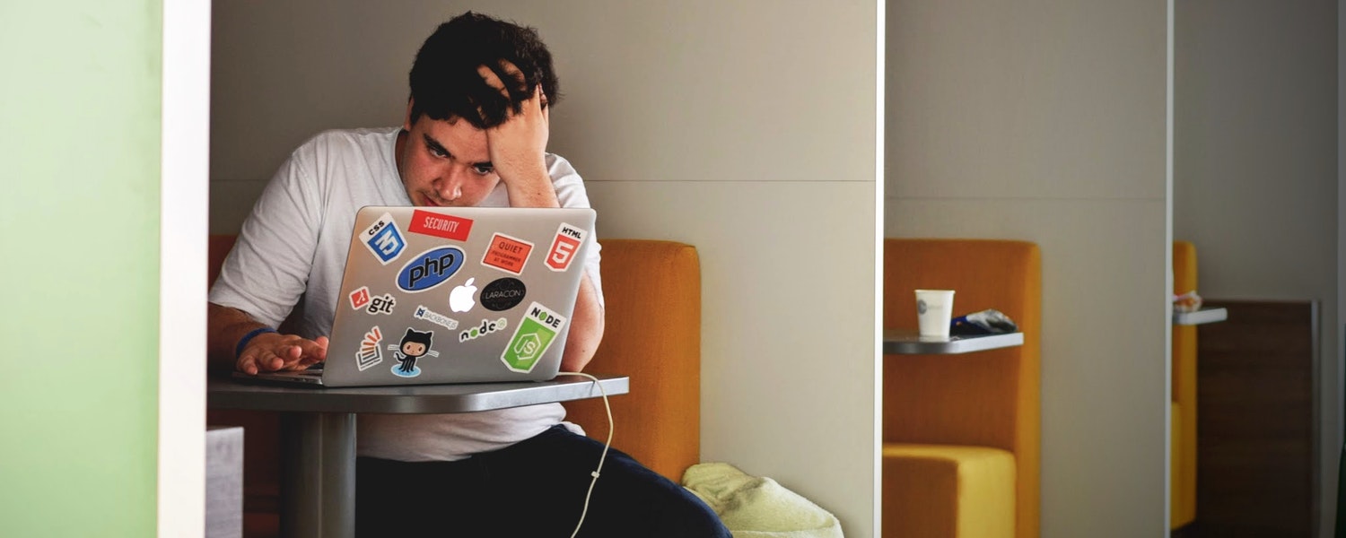student on laptop seeming to be stressed