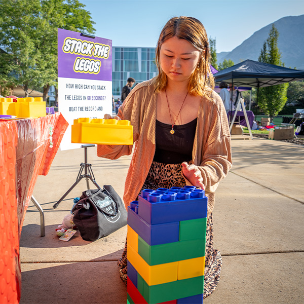 student stacking legos