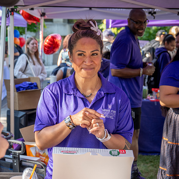 staff member giving away doughnuts