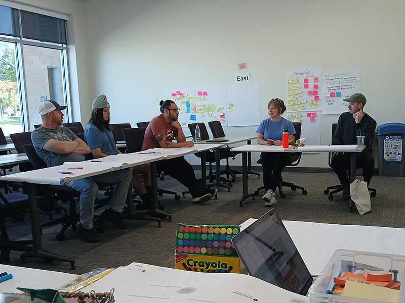 People collaborating at a table in a classroom