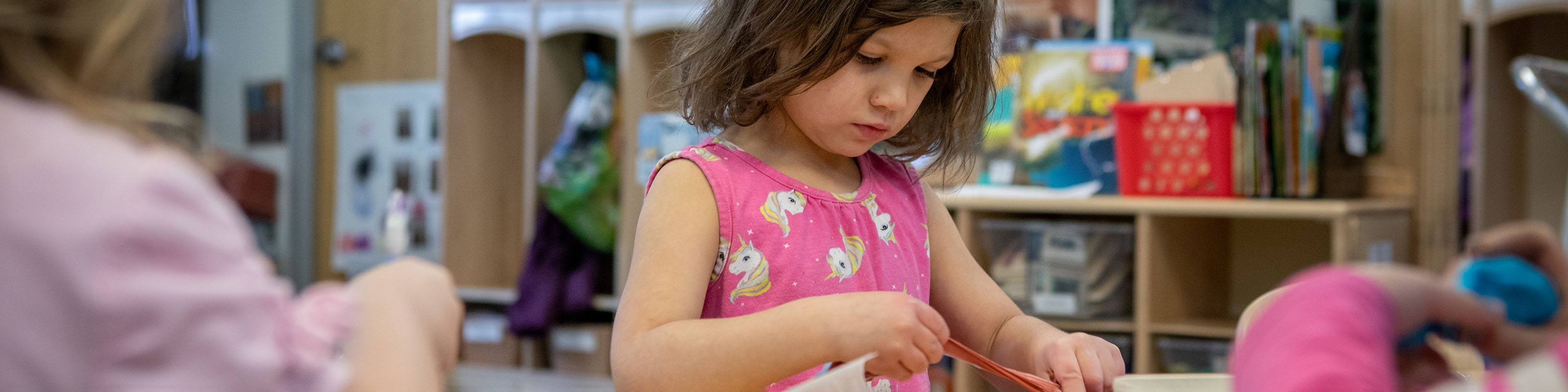 Girl playing with clay in children's school