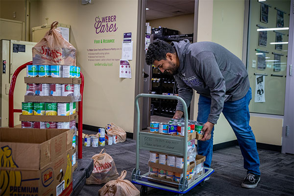 student adding food to pantry