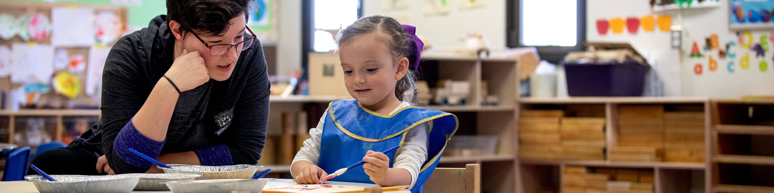 child painting in children's school
