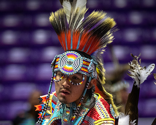 Native American dancing in ceremonial clothing