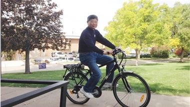 Fred Chiou, assistant professor in Electronics Engineering Technology, rides an electric bike around the Weber State Campus. The bike is part of a solar charging station for electric bikes and vehicles that will ultimately encourage sustainable commuting to the university.
