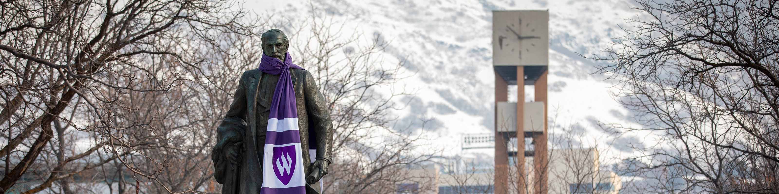 Moench statue with Weber State scarf during winter on WSU campus.