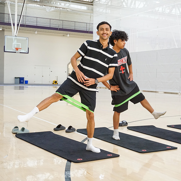 two students using bands during a workout