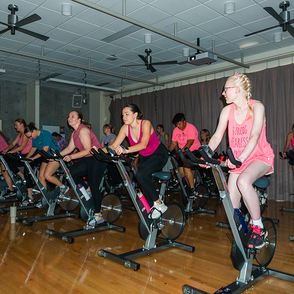 cycle class with students wearing pink shirts