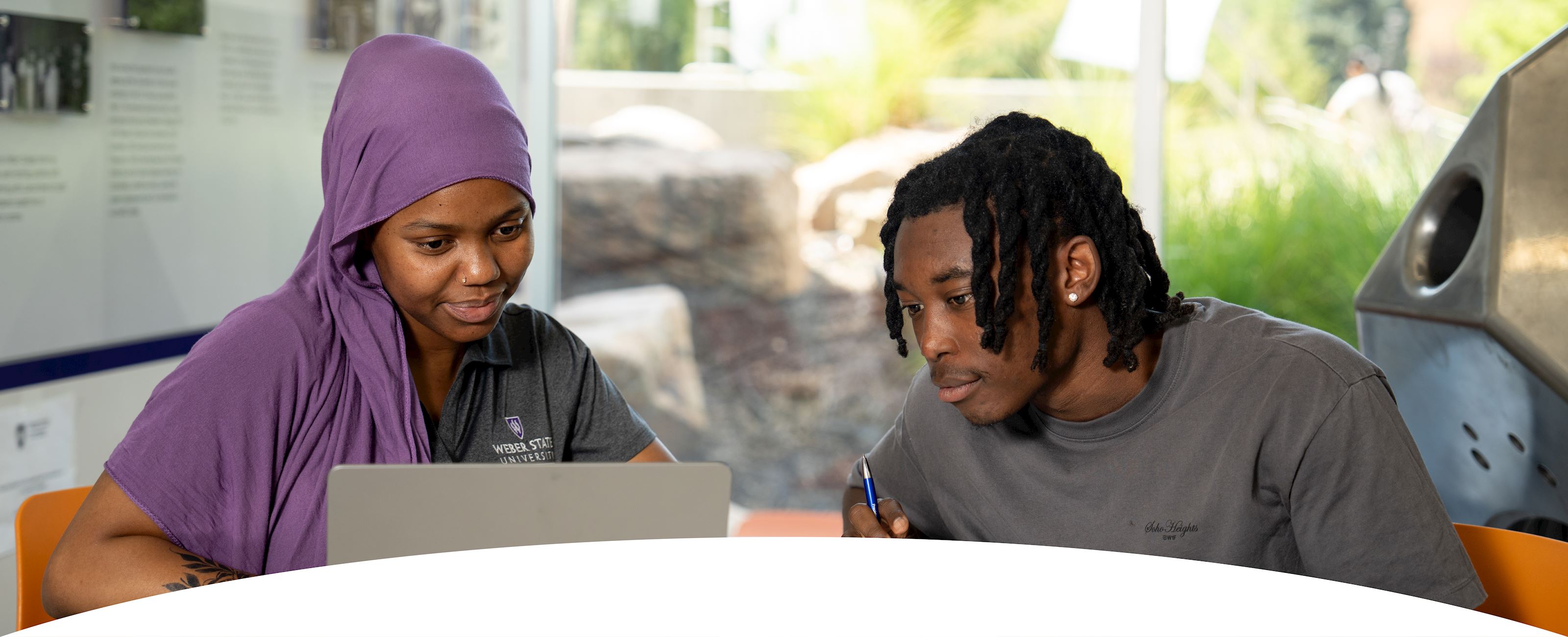 Student and Staff Looking at a Computer
