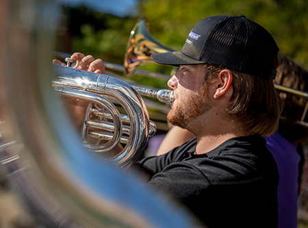 A bane member playing a trumpet.