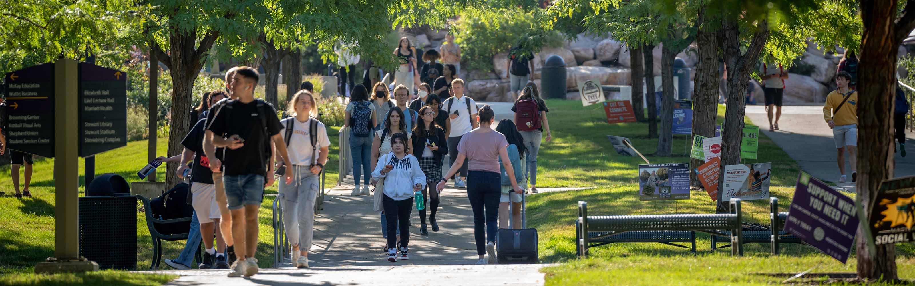 Weber State University students walking outside on campus.