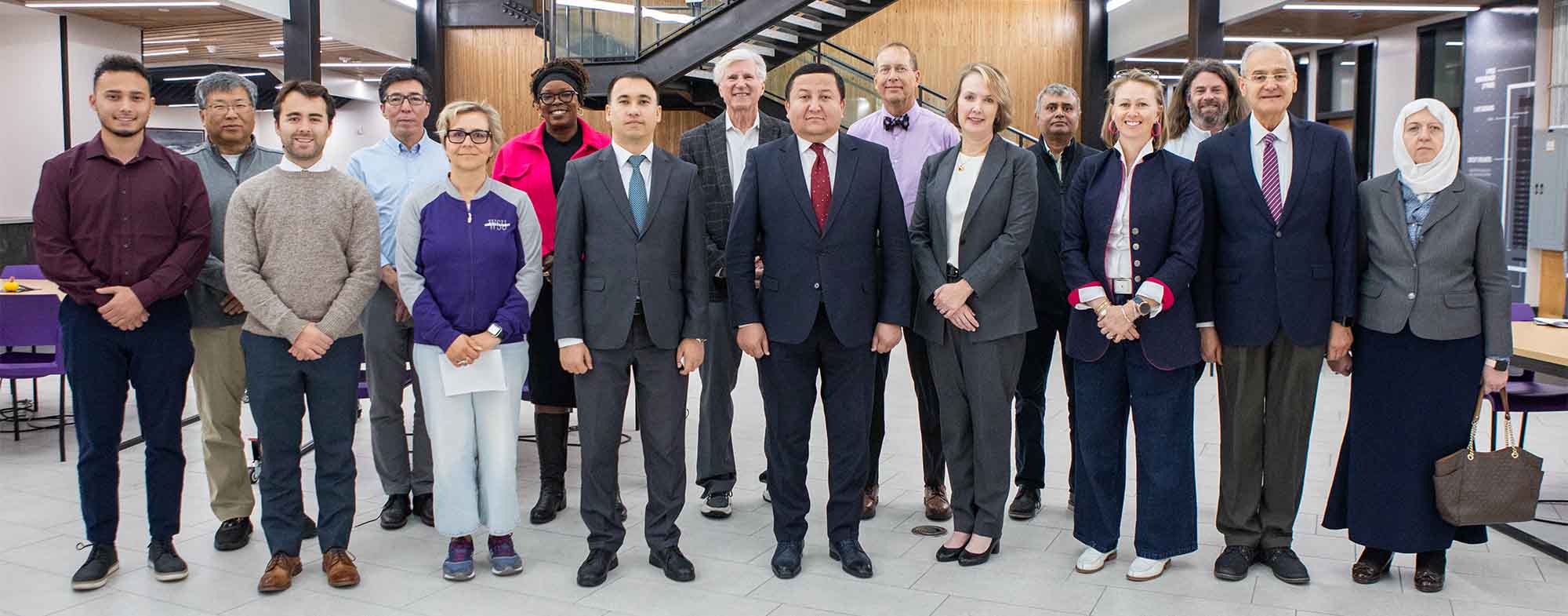 Weber State Staff, Faculty, & Uzbekistan's Ministry of Education standing together for a group photo.