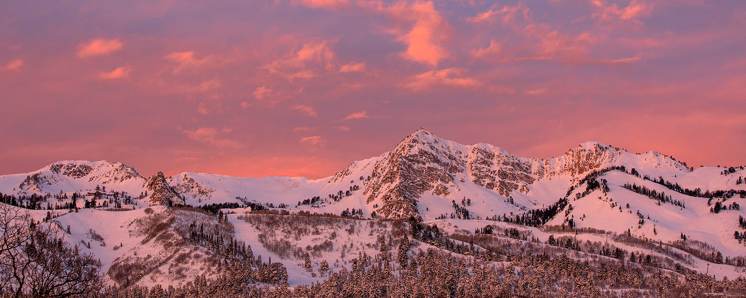 pink sunset over snow covered mountains