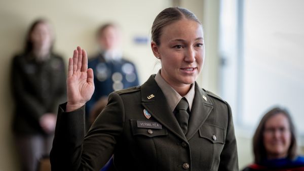 Female Cadet raising right hand during commissioning ceremony