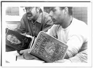 photo of men reading a book of poetry.