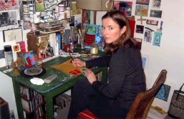 Photo of artist Meri DeCaria at work.