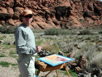 Photo of artist John Collins at work.